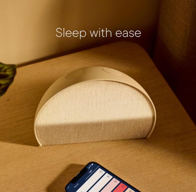cozy winter bedroom ideas - sunrise alarm clock on a nightstand
